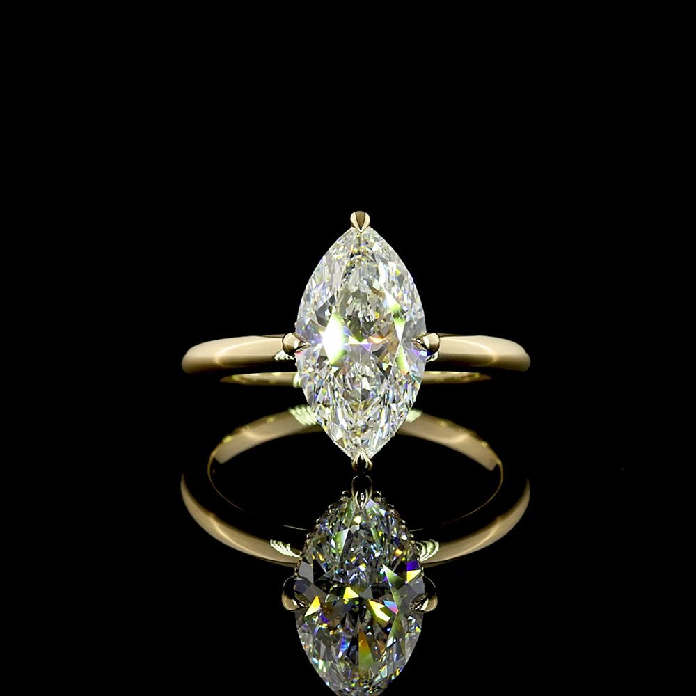 A marquise-cut diamond in a slim yellow gold solitaire setting