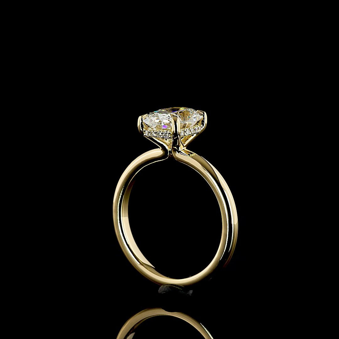 Side profile of a yellow gold ring showing a hidden halo of pavé diamonds beneath the center stone