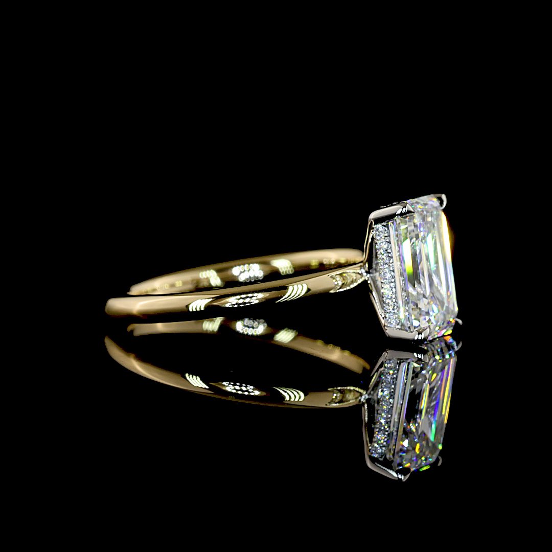 A gold band with a platinum head and hidden halo holding an emerald-cut diamond, seen from the side