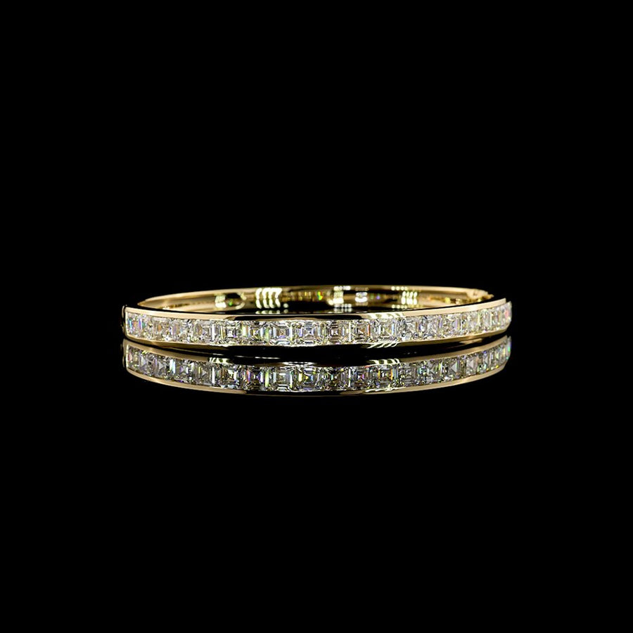 A bangle channel-set with a row of step-cut diamonds