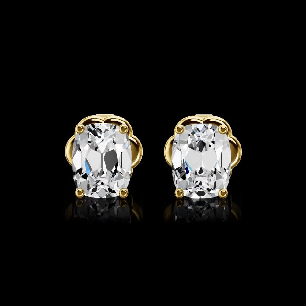 A pair of cushion-cut diamond stud earrings