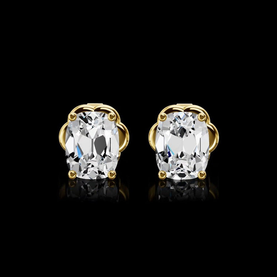 A pair of cushion-cut diamond stud earrings